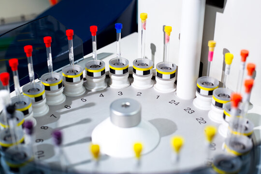 Sample tubes are placed in tray of automated NMR spectroscopy instrument. The samples are arranged by number to form a queue for automatic analysis preparing to identify structure of organic molecules