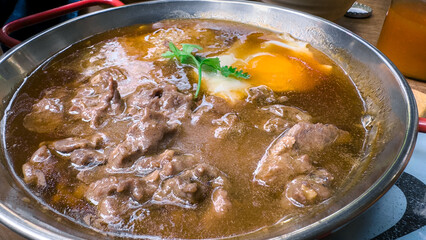 A bowl of stew with Vietnamese meat and an egg. Traditional popular dish Vietnam