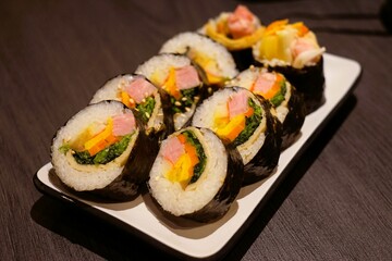 Kimbap is similar to Japanese sushi, but it has a few differences, such as the use of sesame oil in the rice and the inclusion of a wider variety of vegetables and meats.