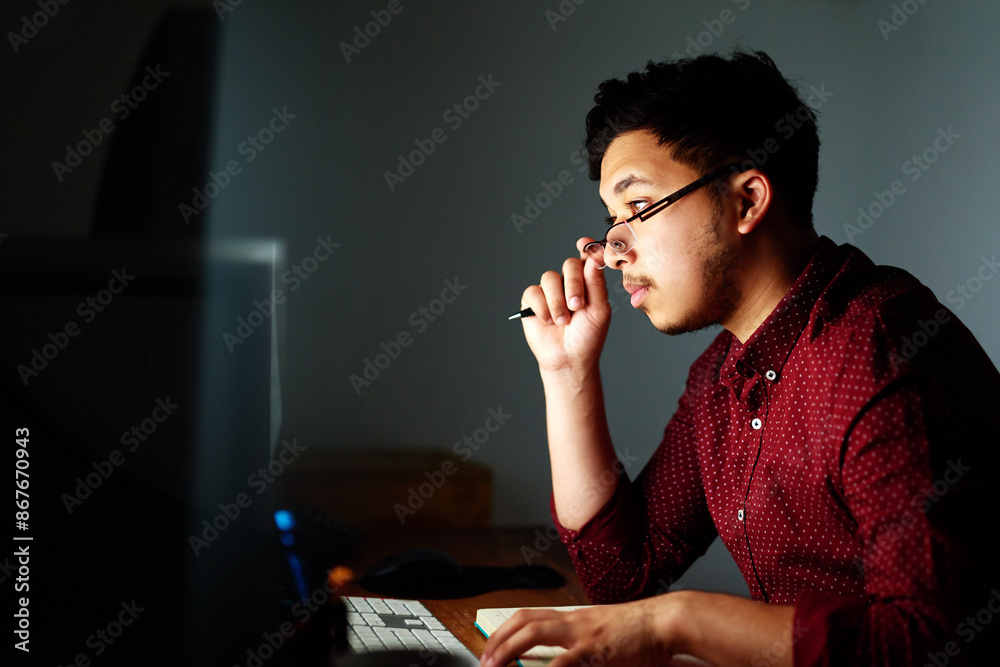 Poster Man, thinking and computer at night in office with notebook, coding information or software programming. Geek developer, pc and notes with glasses for database update, it report and server deadline