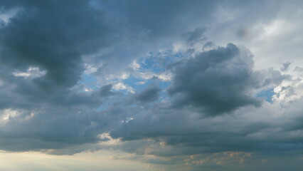 Obraz premium Beautiful dark dramatic sky with stormy clouds before rain or snow. Thunderstorm heaven landscape. Timelapse.