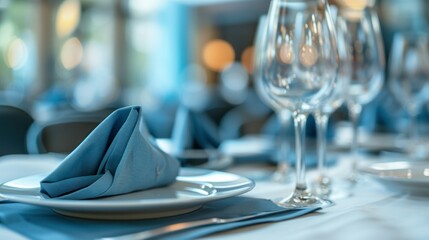 Elegant table setting with blue napkins and empty wine glasses for fine dining experience