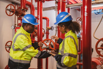 Engineer or technician work checking Fire suppression system and fire equipment. Engineer check red...