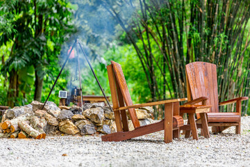 The background of the park decoration has a corner table and wooden chairs for sitting and relaxing during the day. Amidst the various flowers, the beauty of the green grass.