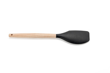 Black spatula with wooden handle. The spatula is long and thin. He sits on a white background