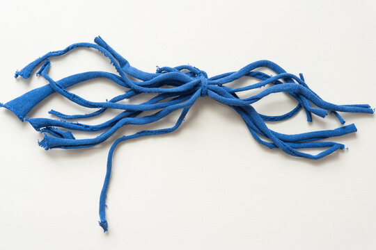 upcycled t-shirt strips isolated on blank paper