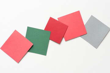 five paper squares partly overlapping on blank paper