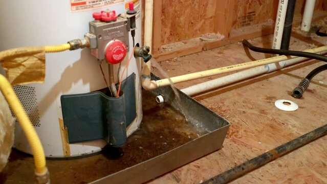 Water gushing out of water heater drain