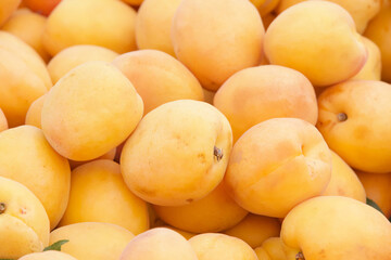 Close up on pile of fresh ripe apricots sale at farmers market.. View from above.