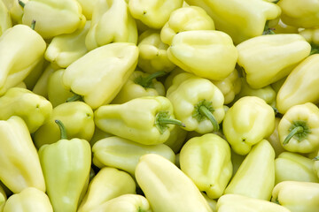 Close up on pile of sweet yellow peppers sale at farmers market.. View from above.