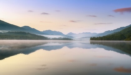 Fototapeta premium calming rhythms, serene mountain landscape reflected in calm lake waters at dawn, misty and peaceful soft light