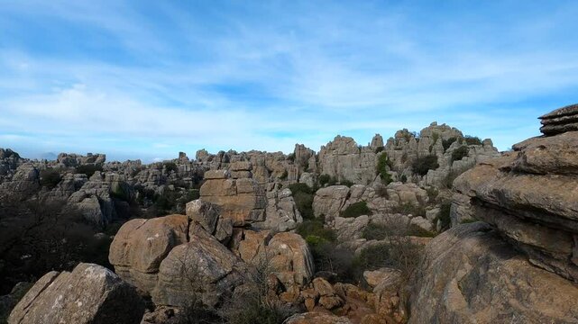 Hiking in the Torcal de Antequerra National Park, limestone rock formations and known for unusual karst landforms in Andalusia, Malaga, Spain.