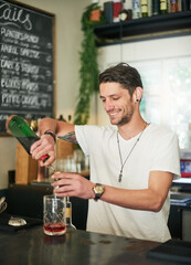 Fototapeta premium Man, cocktail and bartender pouring for order, service and alcohol at social lounge in nightclub. Barman, smile and bottle of liquor, spirits and discount for drinks at happy hour event in pub