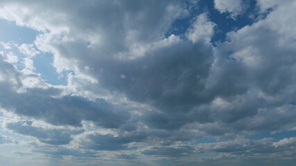 Cloud stratocumulus nature background. Blue sky with stratus clouds and sun. Nature background of...