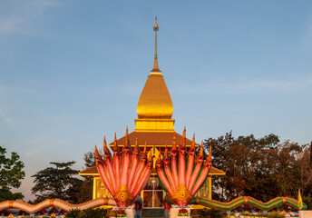 A large gold building with a red roof and a gold spire