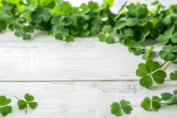 gold lay composition with clover leaves on white wooden table, space for text