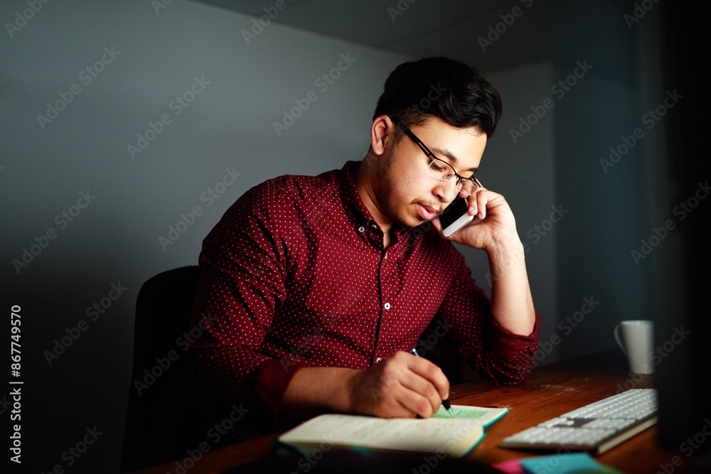 Leinwandbilder Man, writing and night with phone call in office for communication on working late, deadline and networking. Male employee, dark and conversation for feedback on project, workplace and schedule notes