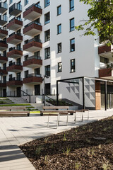 A fragment of a residential building and outbuildings with bicycle parking