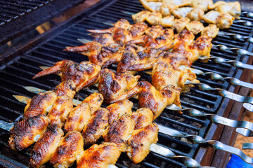 Grilled chicken wings on charcoal barbecue are typical of American cuisine