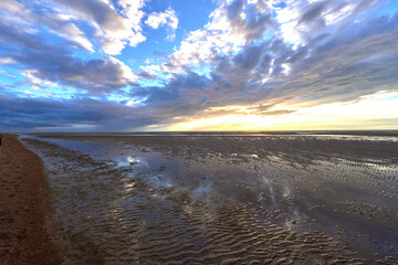 Low clouds over a Old Hunstanton beach at sunset