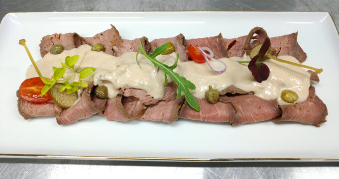 vitello tonnato is a dish of thinly sliced pieces of marinated veal, seasoned with a cream sauce, one of the ingredients of which is tuna. Is a cold dish or snack