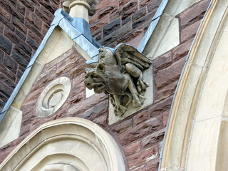 Closeup of a gargoyle on an old stone building.