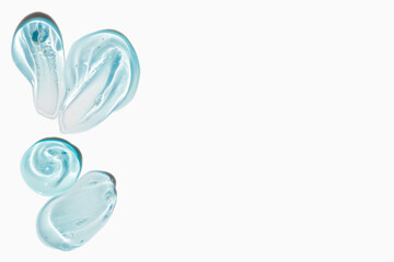 Smears of cosmetic texture of blue gel on a light background