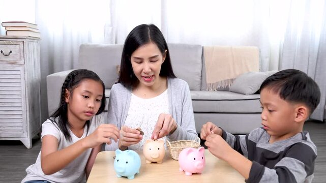 Female teaching children to save money in piggy bank by collect leftover coins after school, Mother imparts life skills to her children, guiding them through a task focus on learning by doing with mom