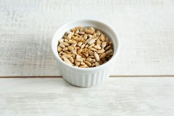 A view of a small bowl of roasted sunflower seeds.