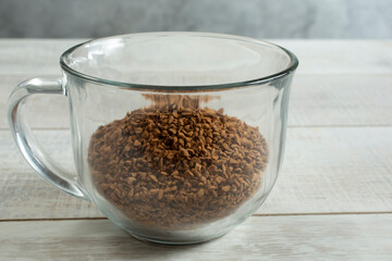 A view of a glass mug of instant coffee.