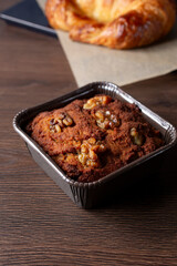 A view of a banana nut muffin in a small baking pan.