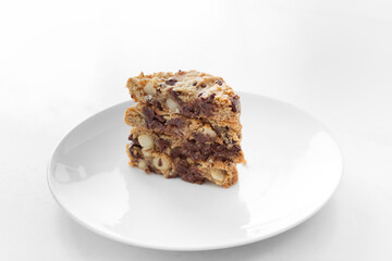 A view of a sliced stack of cookies, featuring chocolate chip and macadamia nuts.