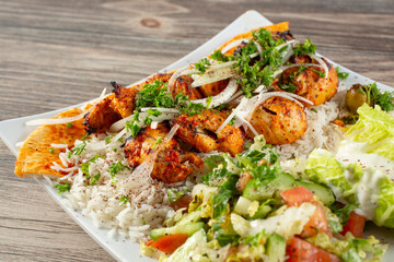 A closeup view of a chicken kebab plate.