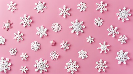 Crocheted white snowflakes and stars on pink background in Scandinavian style