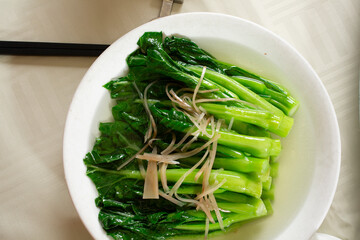 A top down view of a gai lan entree.