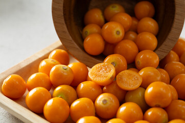 A closeup view of a pile of orange colored gooseberries.