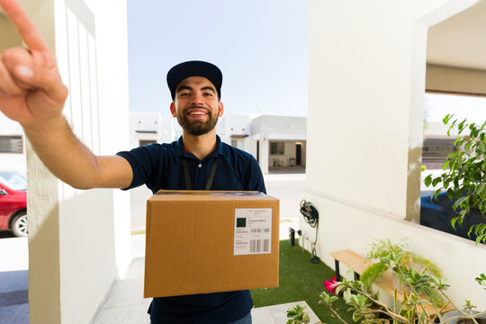 Courier in uniform rings a doorbell with a package, providing reliable delivery service and a smooth shopping experience