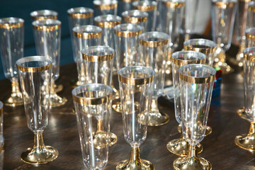 A view of a table full of plastic Champagne glasses.