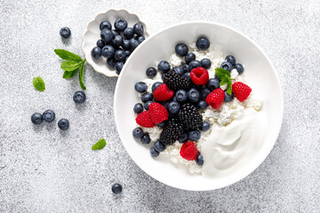 Cheese cottage with yogurt and fresh berries. Curd with blueberry, raspberry and blackberry, top...