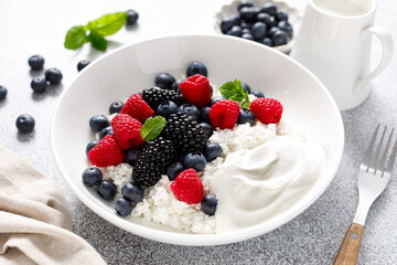 Cheese cottage with yogurt and fresh berries. Curd with blueberry, raspberry and blackberry