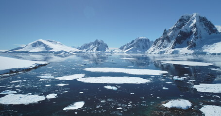Antarctica ocean bay aerial landscape in sunny day. Melting ice floe on water surface, blue sky,...