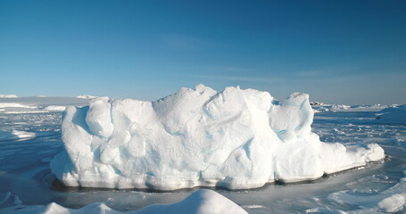 A massive block of ice in frozen ocean surface. Arctic environment preserve of ice. A breathtaking...