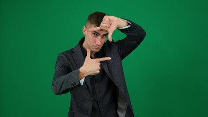 Frame with hands emotions of handsome man guy on green background chromakey close-up dark hair young man boss work advertising