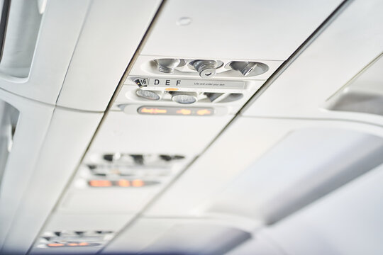 Selective focus on the ceiling of a passenger aircraft, where safety elements, buttons and switches such as an oxygen mask are located. With space to copy. High quality photo