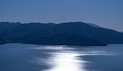 moonlit lake and hills