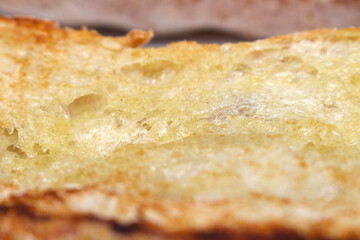 close up of bread. bread with melted butter. bread and butter. meal details.