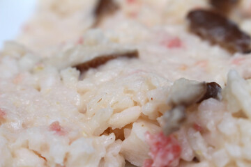 details of sausage risotto with mushrooms. meal with selective focus. rice with mushrooms and sausage. food details.