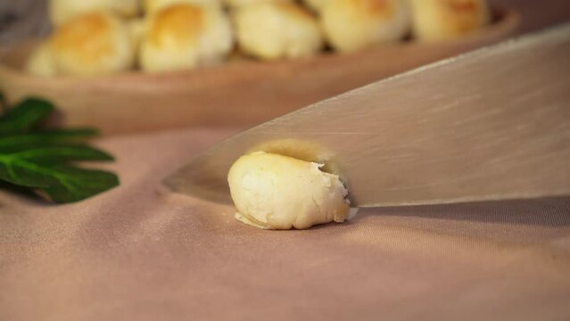Slicing the mini cake named Bakpia to see the flavor inside. Cheese inside