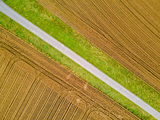 golden wheat field, agricultural field with artistic lines and patterns diagonally separated by the...