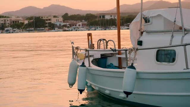 Boat tied to dock during Sunset. Mallorca
